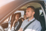 man in the car with his family on vacation