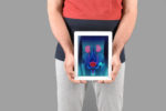 man holding tablet in front of waist with prostate organs