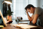 man at his desk stressed