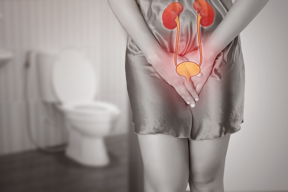 woman experiencing urinary pain in bathroom