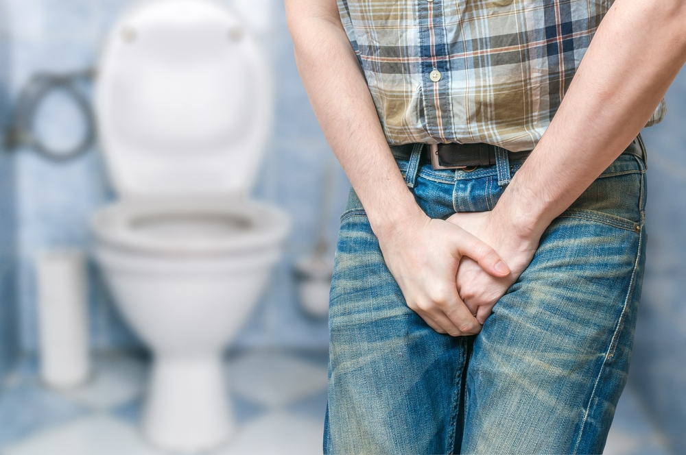 man holding bladder because he needs to pee