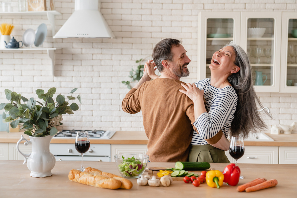 Couple dancing in kitchen.