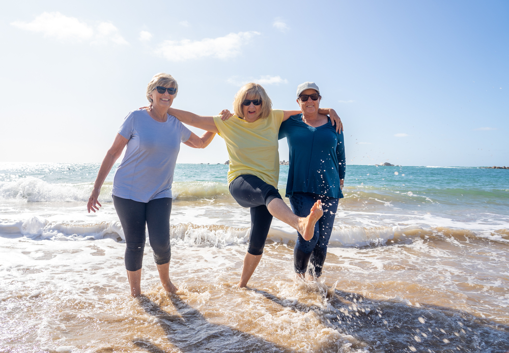 Women laughing at beach.