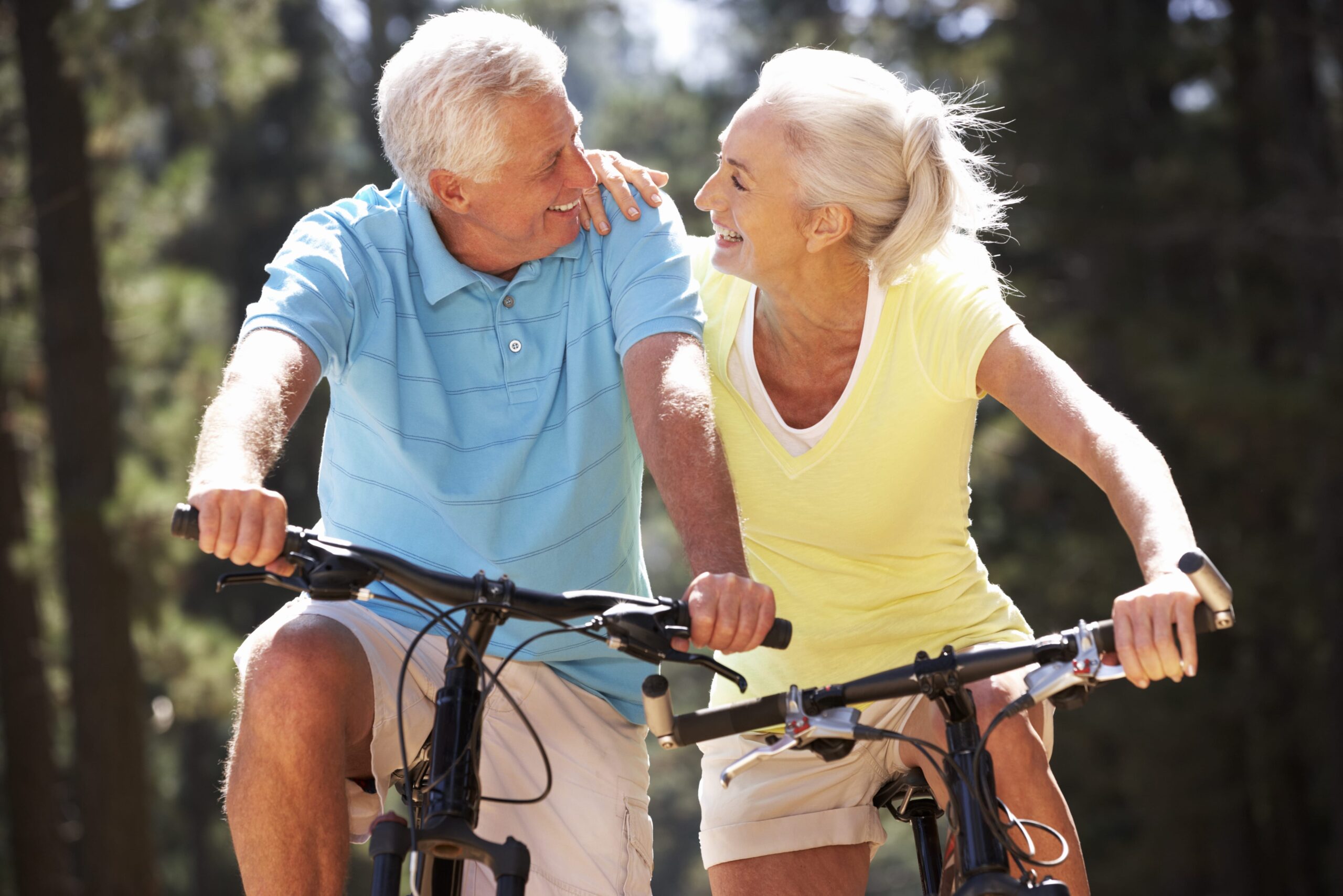Older couple riding bikes.