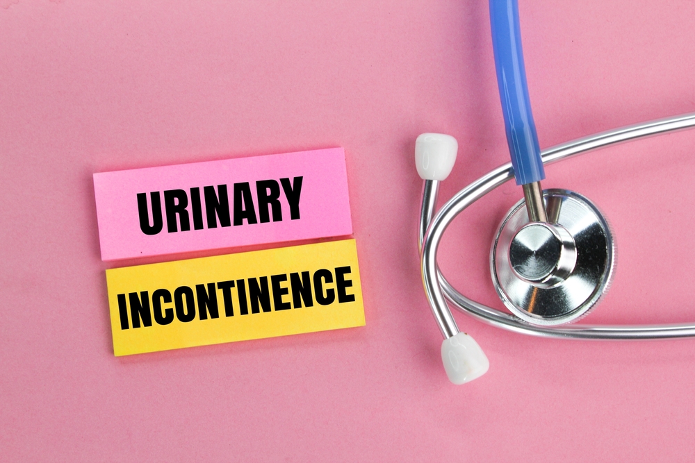 stethoscope and colored paper with the word Urinary incontinence.