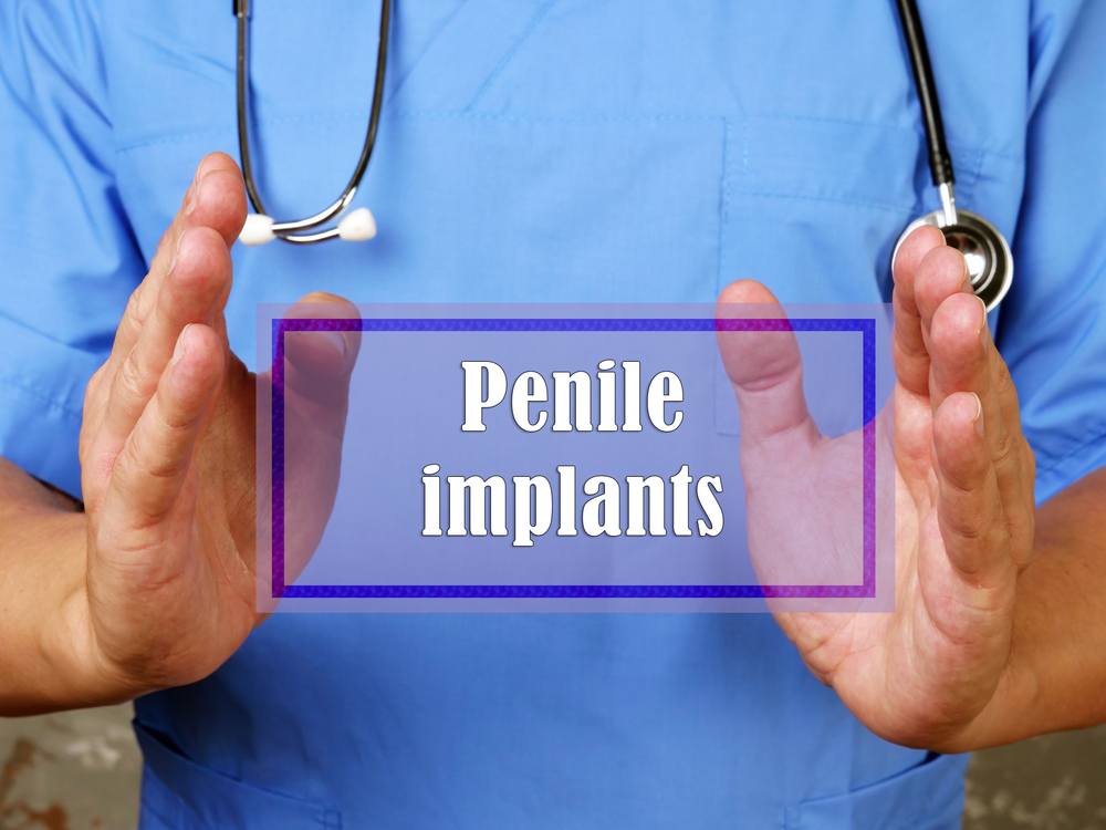 doctor holding penile implant sign